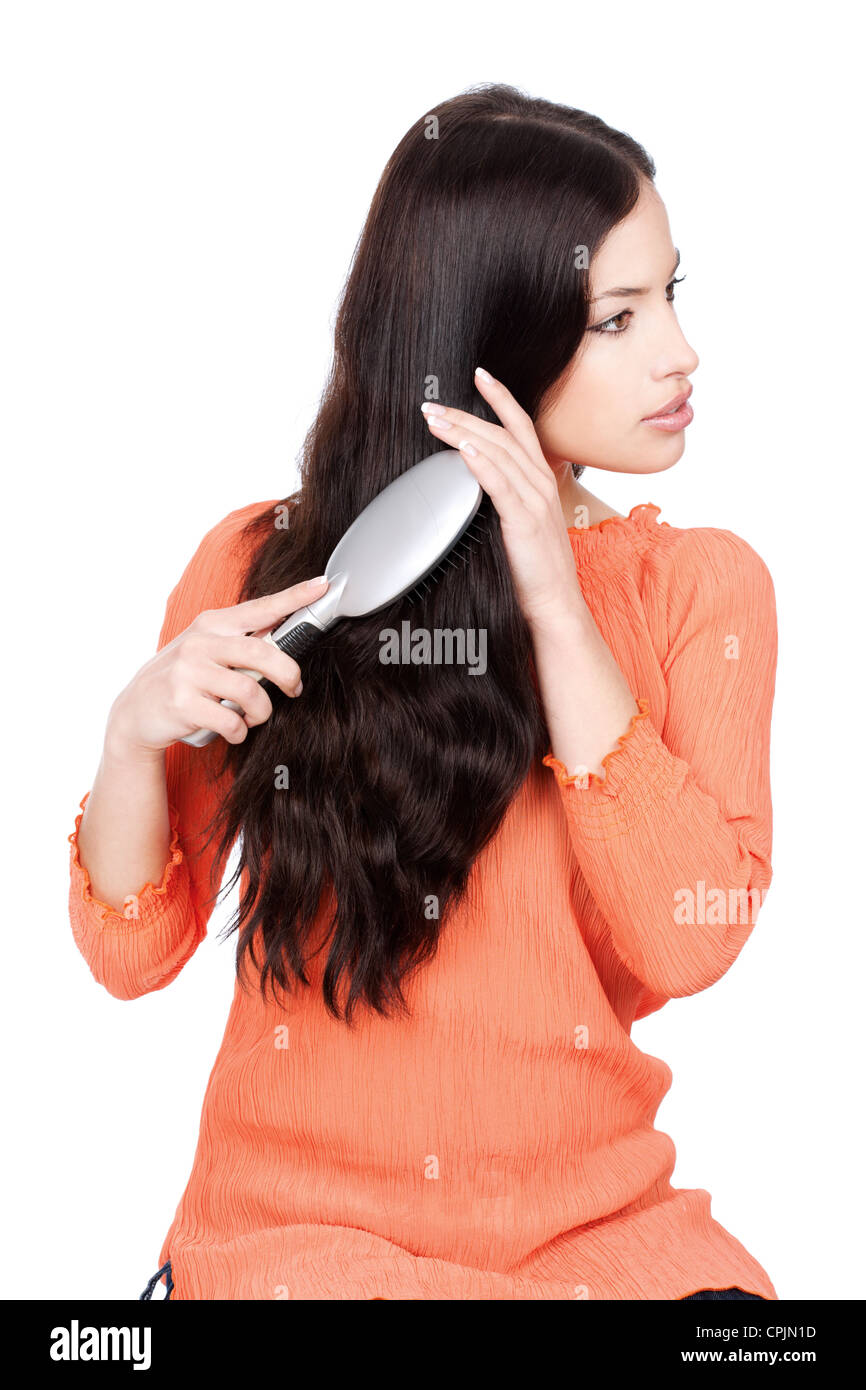 pretty woman combing her hair, isolated on white background Stock Photo