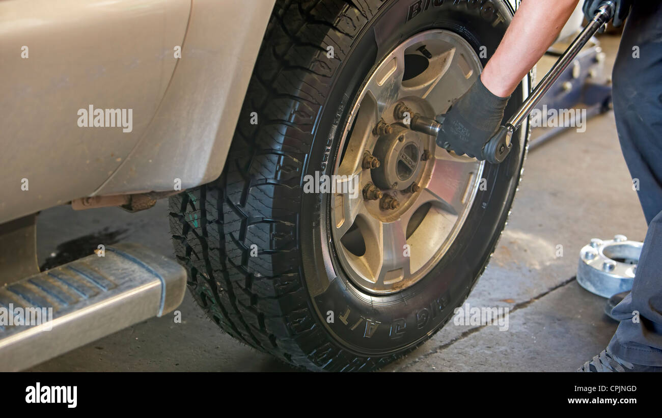 Garage mechanic, technician changes a tire in an automotive shop Stock Photo Alamy