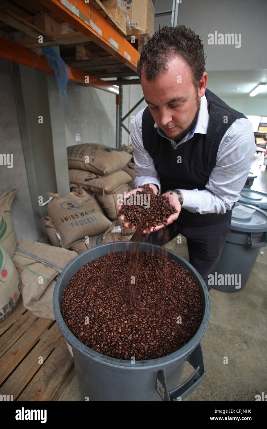 Hayden Thompson of Nelson roasters Pomeroy's with coffee beans, New