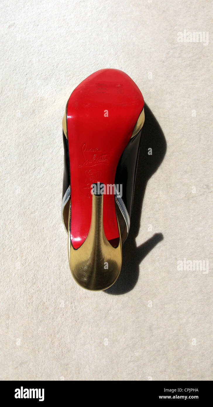 Christian Louboutin shoe with his trademark red sole Stock Photo