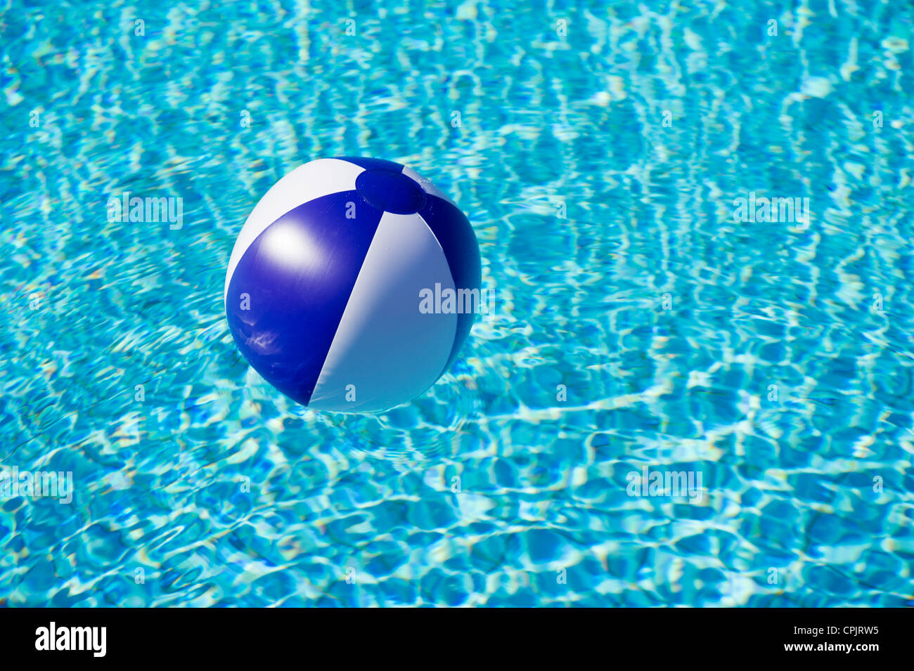 Floating blue and white beachball in swimming pool Stock Photo Alamy