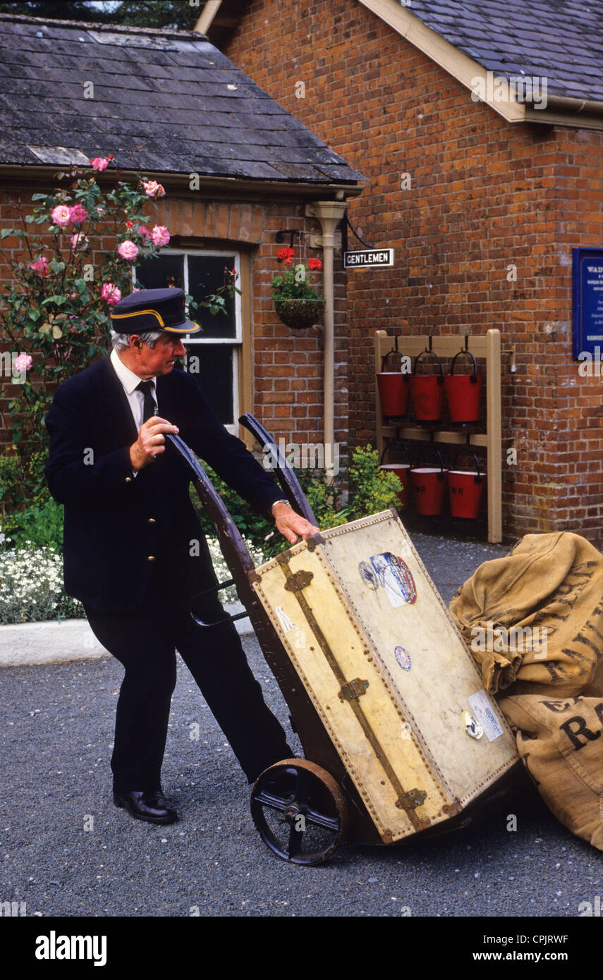 station master moving luggage on platform at staverton station on the buckfastleigh steam railway , staverton, devon uk Stock Photo