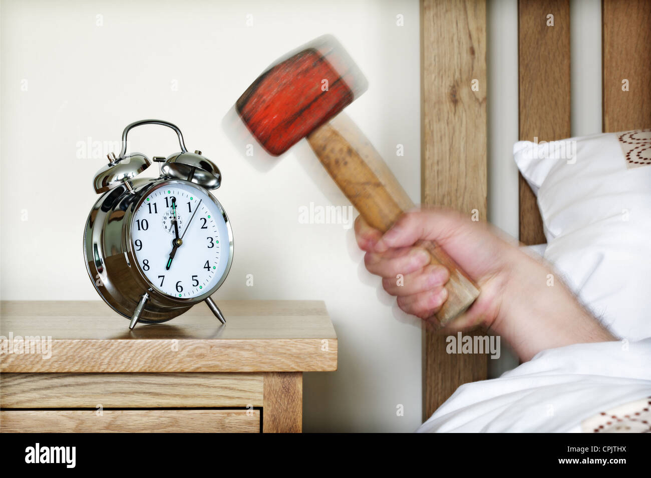 Alarm clock and sledgehammer Stock Photo