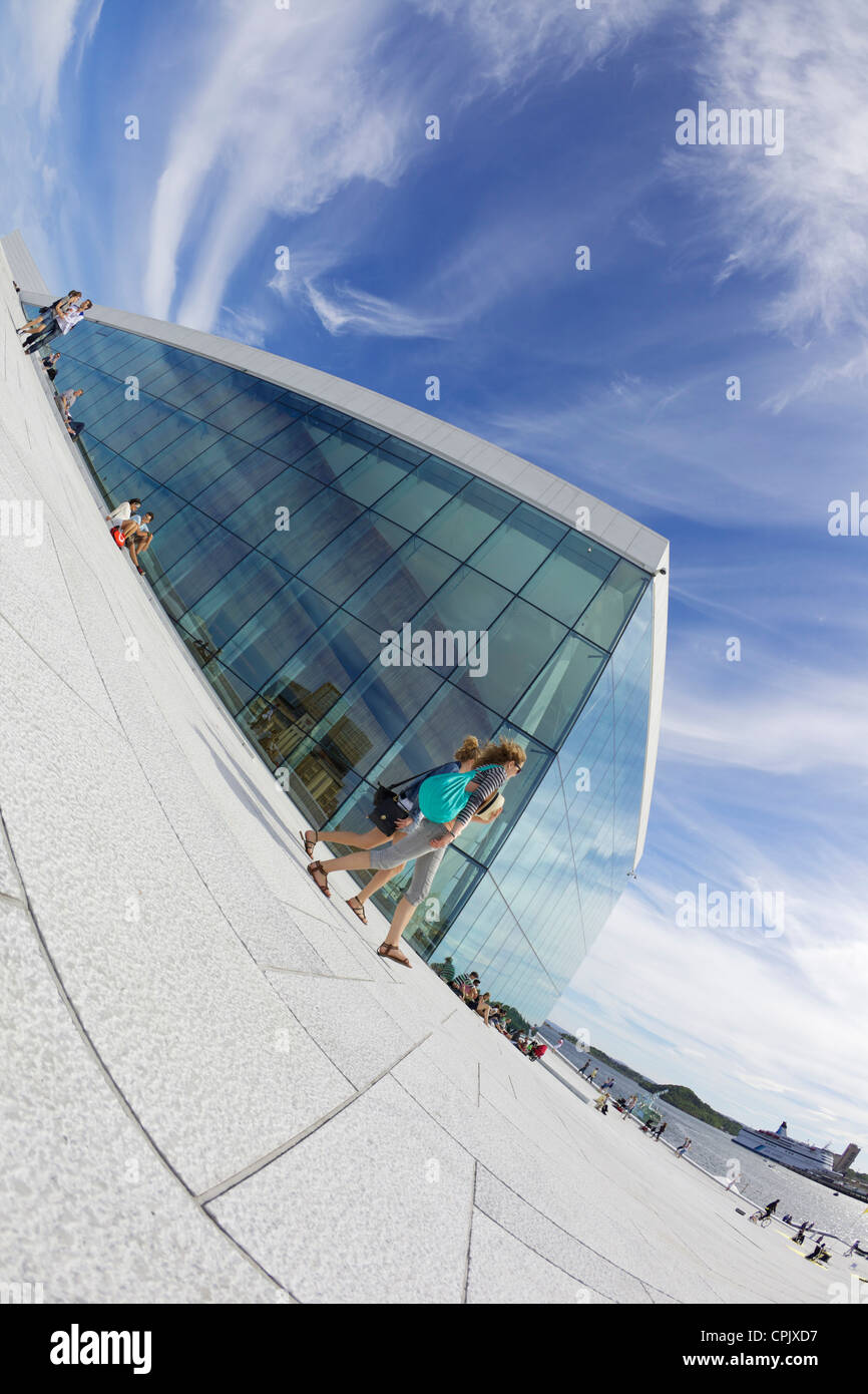 Visitors and tourists walking outside the Oslo Opera house exterior in summer sunshine, city centre, Norway, Europe Stock Photo