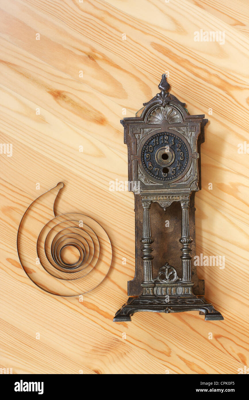 Body and mainspring of old clock on light wood Stock Photo