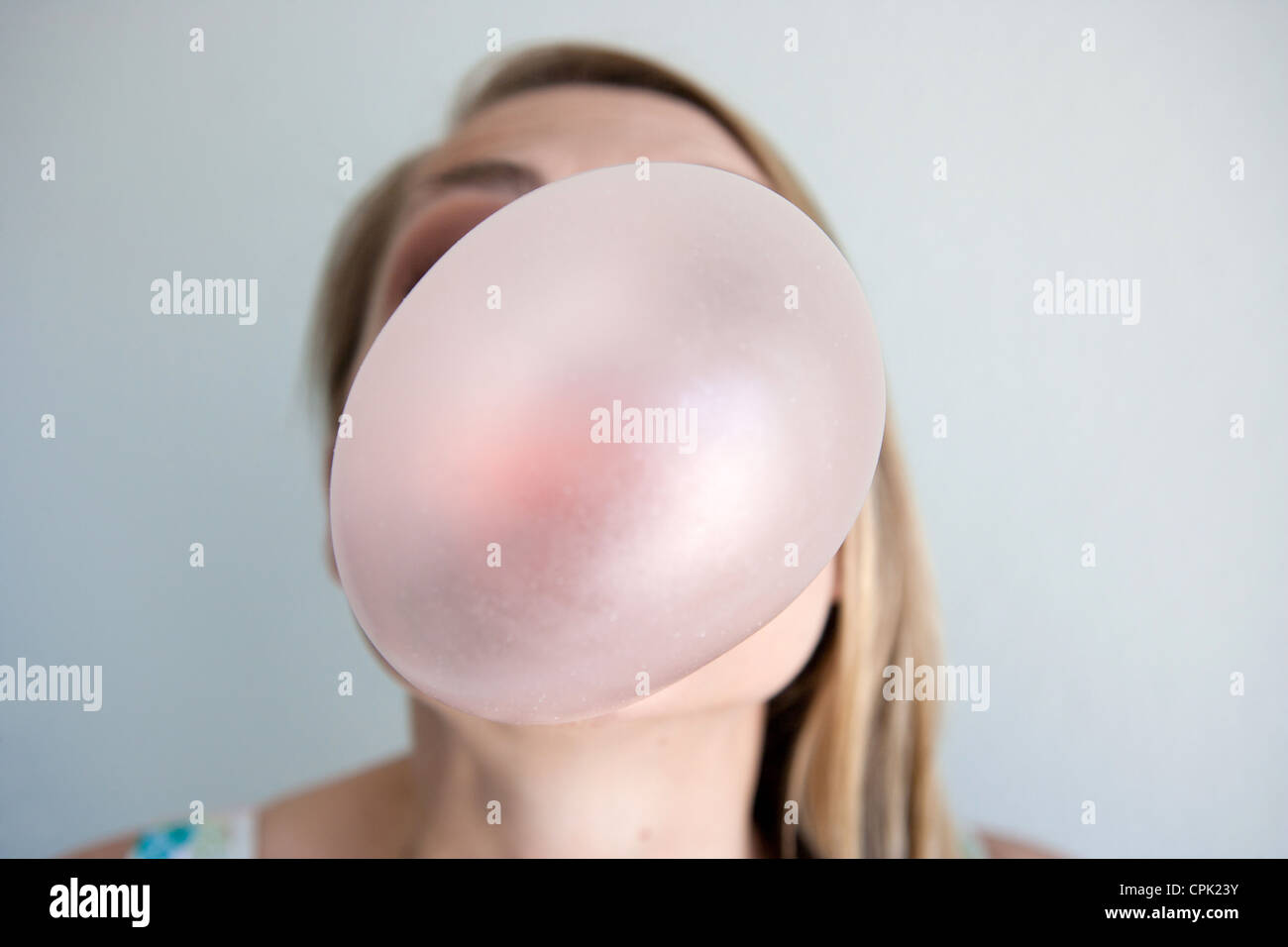 Woman blowing large bubble. Stock Photo