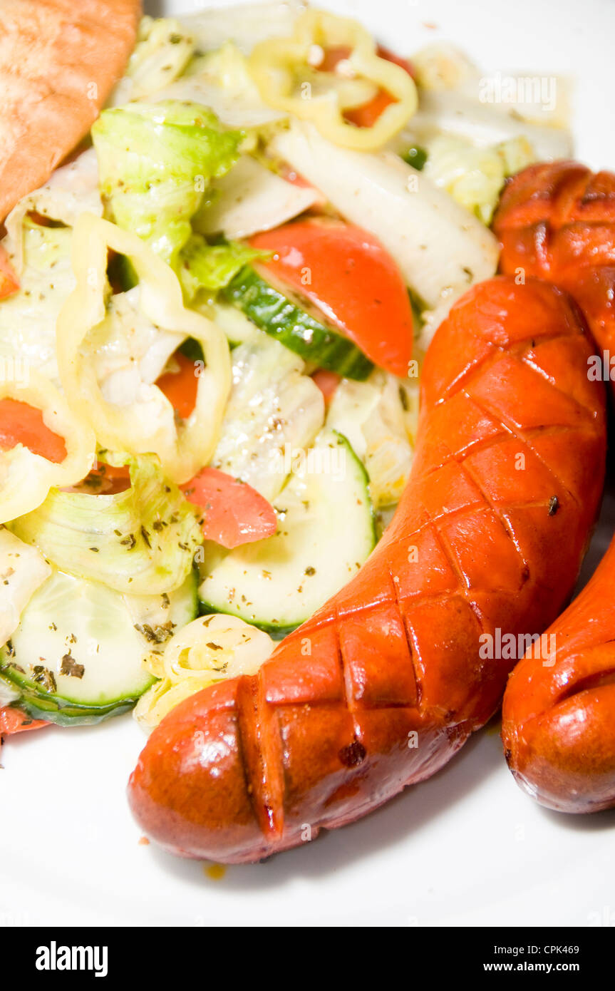debrecziner spicy Hungarian sausage with salad as photographed in Budapest Hungary Stock Photo