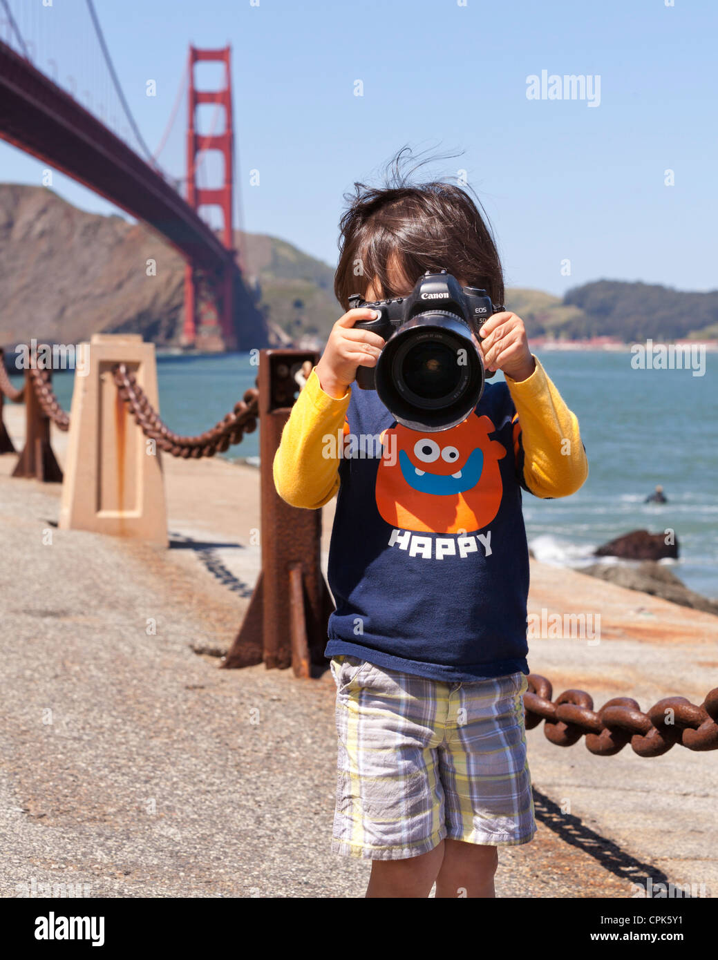 Child photographer taking pictures with dSLR camera - USA Stock Photo