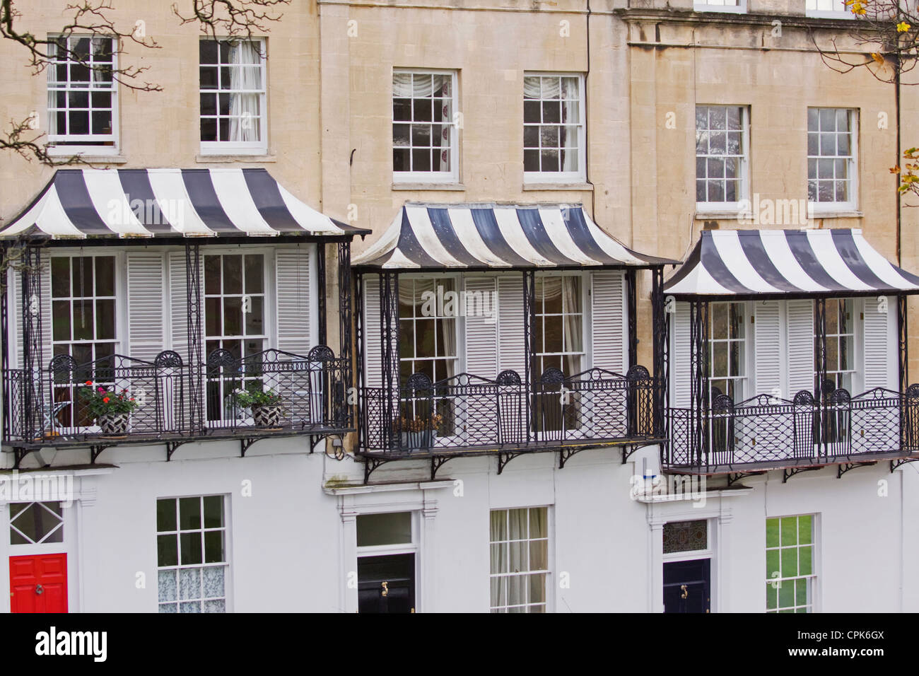 Striped canopies above the balconies of terraced housing in