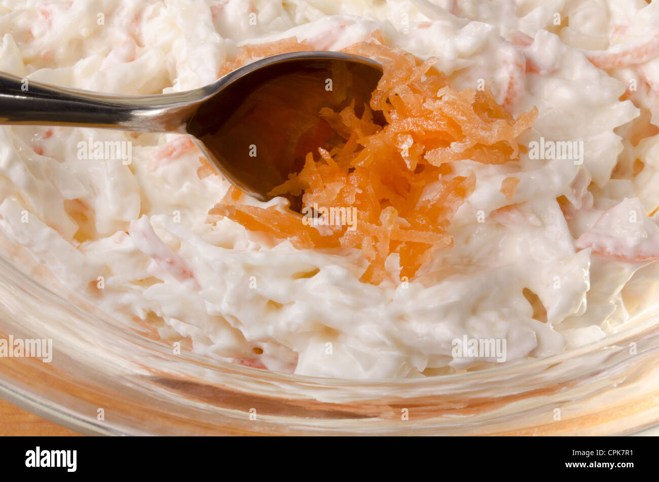 put some grated carrot on to an irish coleslaw salad Stock Photo