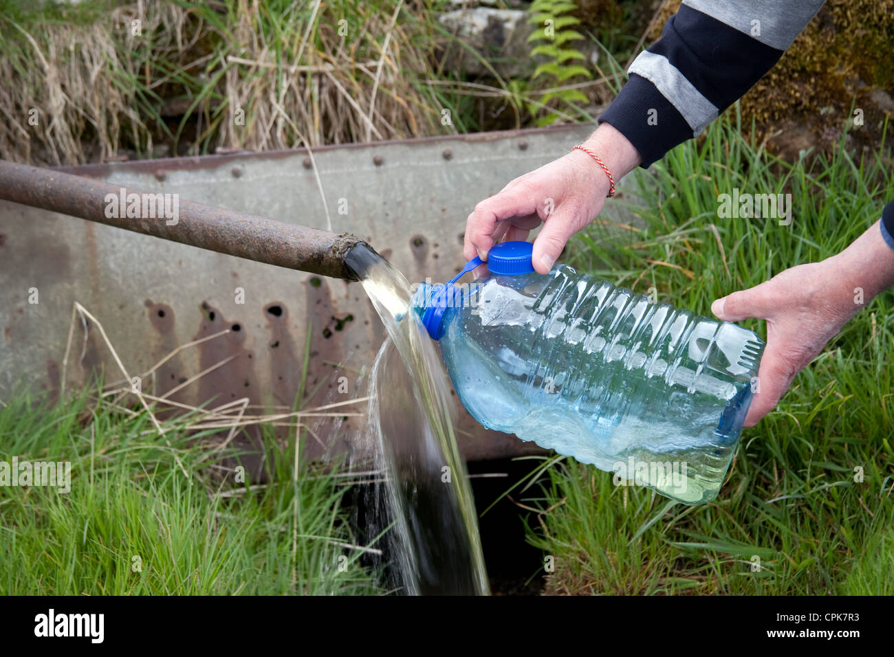 Man Collecting Spring Water in the Yorkshire Dales, near Keld Stock