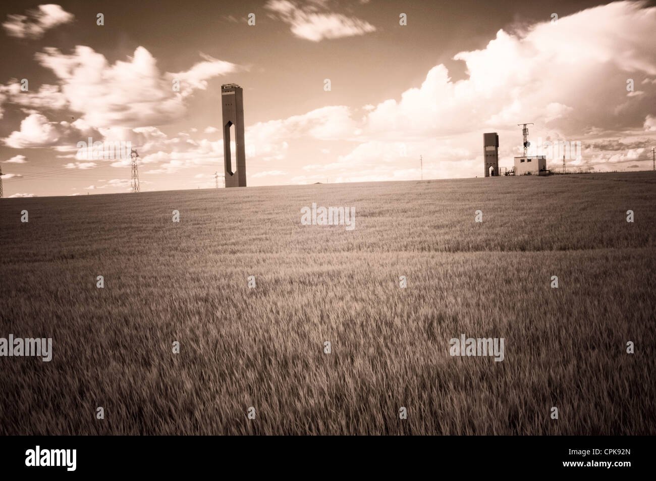 Infrared image of solar plant towers in a wheat field, Sanlucar la Mayor, Seville, Spain Stock Photo