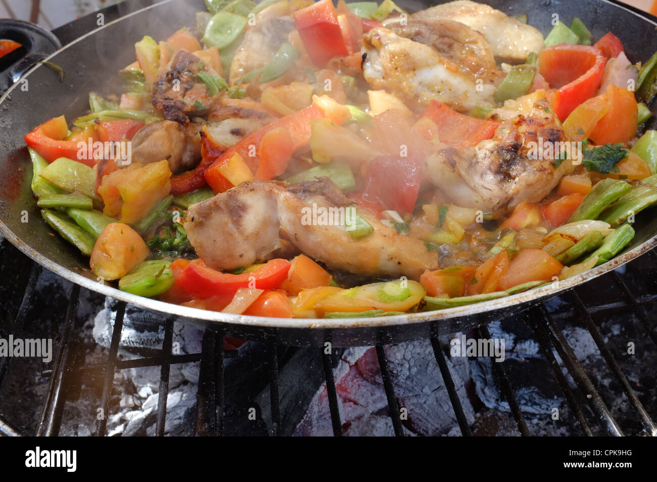 A paella pan at its initial cooking steps Stock Photo Alamy