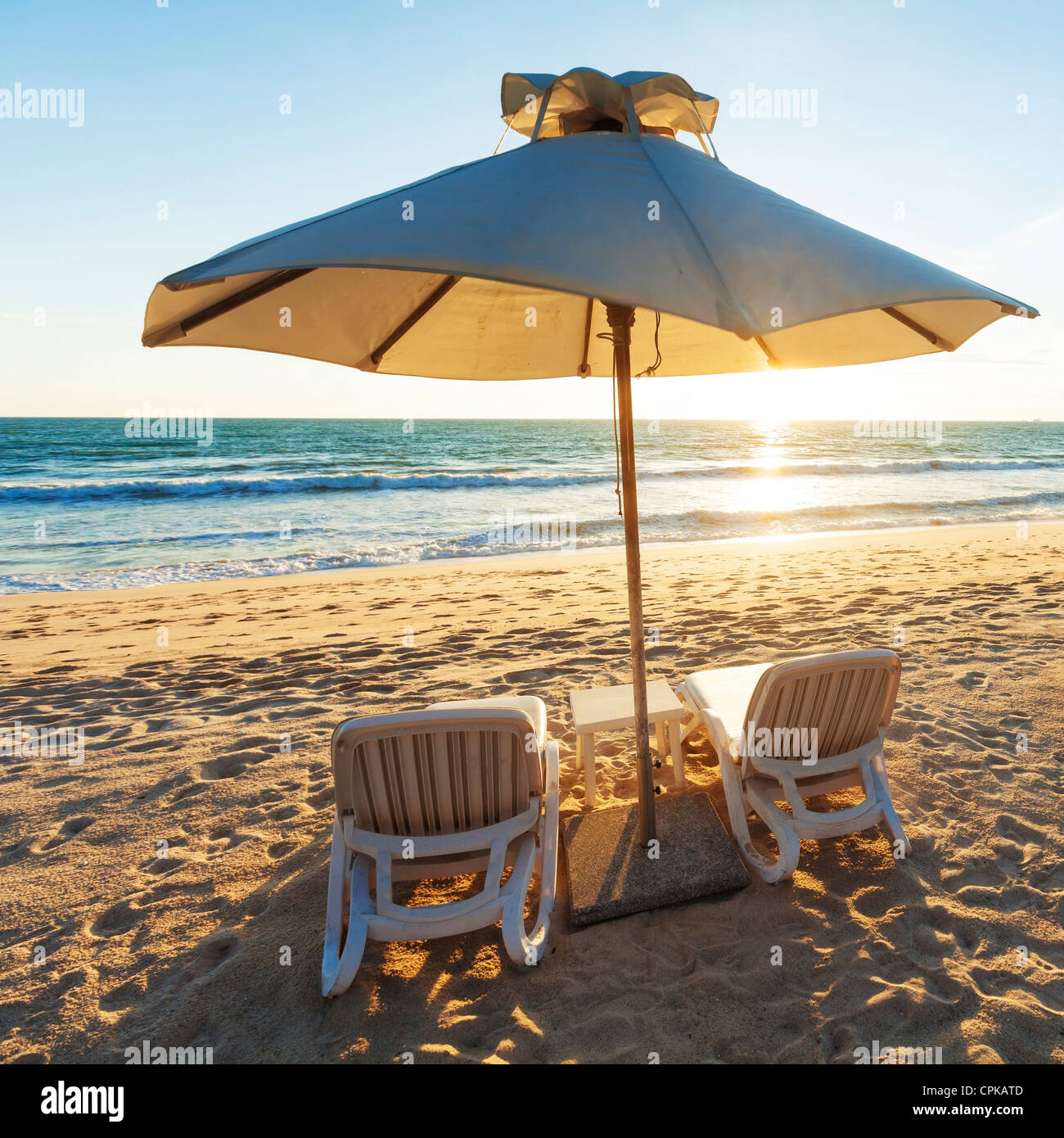 Two beach chairs and parasol. Square composition. Stock Photo