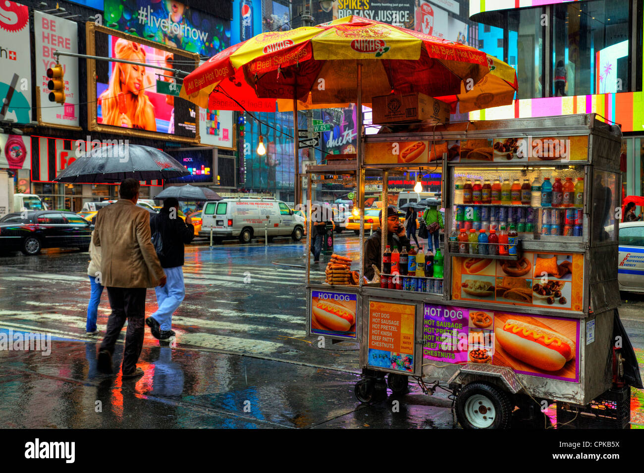 typical-street-vendor-selling-hot-dogs-from-cart-in-rain-new-york-city