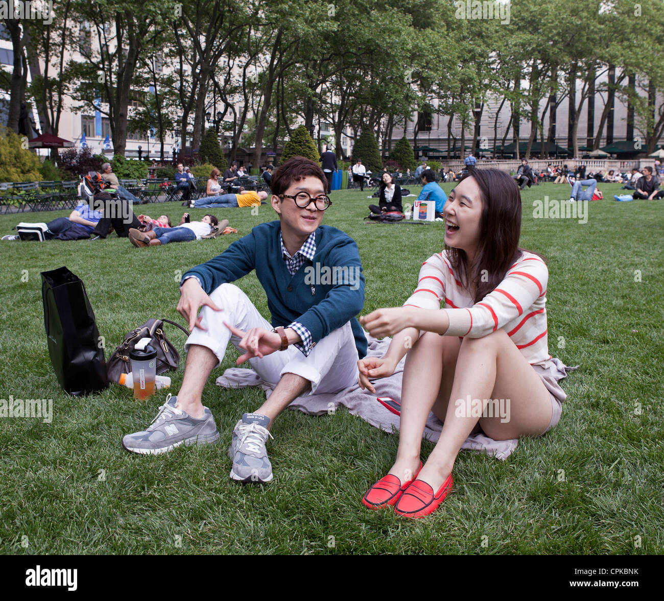 A young man and woman share a laugh in Bryant Park in New York City ...