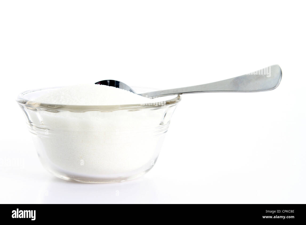 Granulated sugar on white background with teaspoon Stock Photo