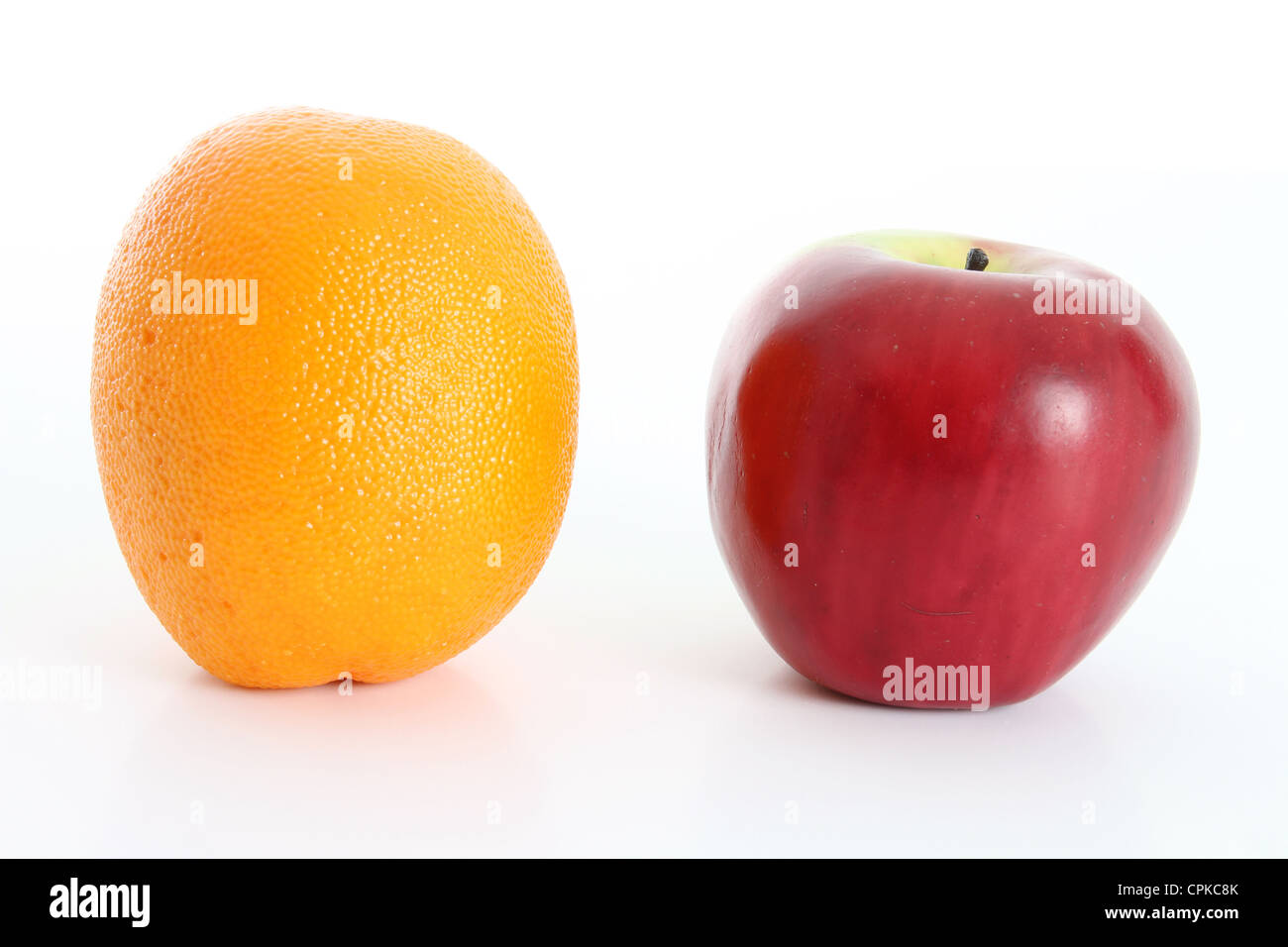 Comparing apples to oranges on white background Stock Photo Alamy