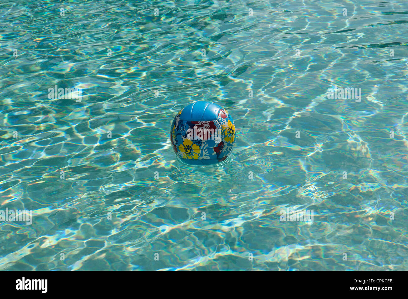 Colorful plastic ball floating in motel swimming pool in Florida. Stock Photo