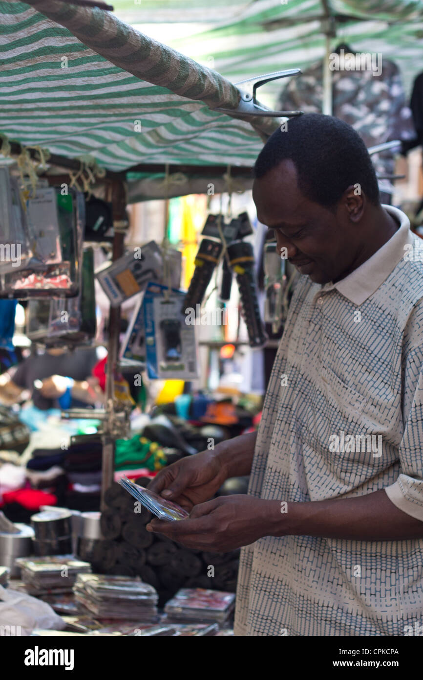Man browsing items in street market Brixton Stock Photo