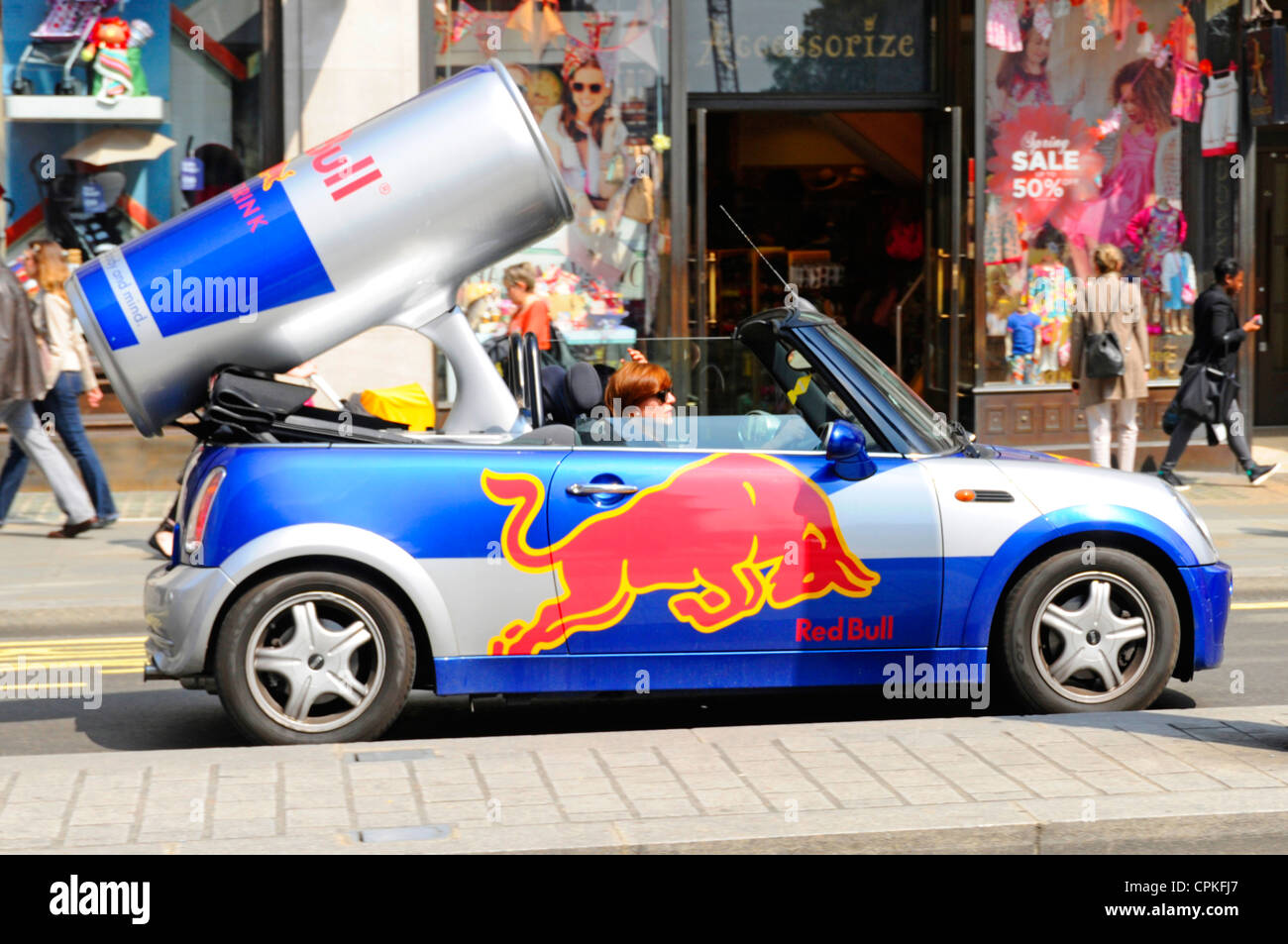 Mini convertible car converted to promote Red Bull drink by incorporating large can Stock Photo