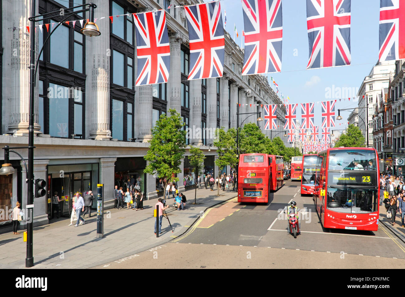 Oxford Street Union Jack Flags Queens Jubilee 2012 Olympics celebrations buses outside Selfridges shopping department store West End London England UK Stock Photo