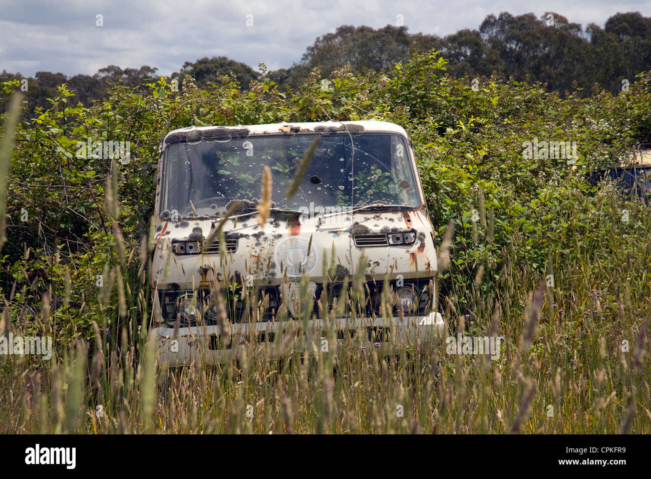 old truck rusting away in the countryside, left for scrap Stock Photo