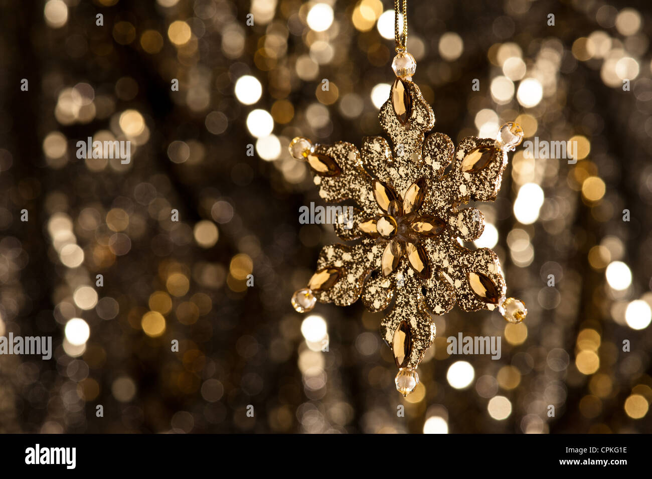 white winter background with glittering snowflake on foreground, artificial  snow and beads for Christmas tree decoration Stock Photo