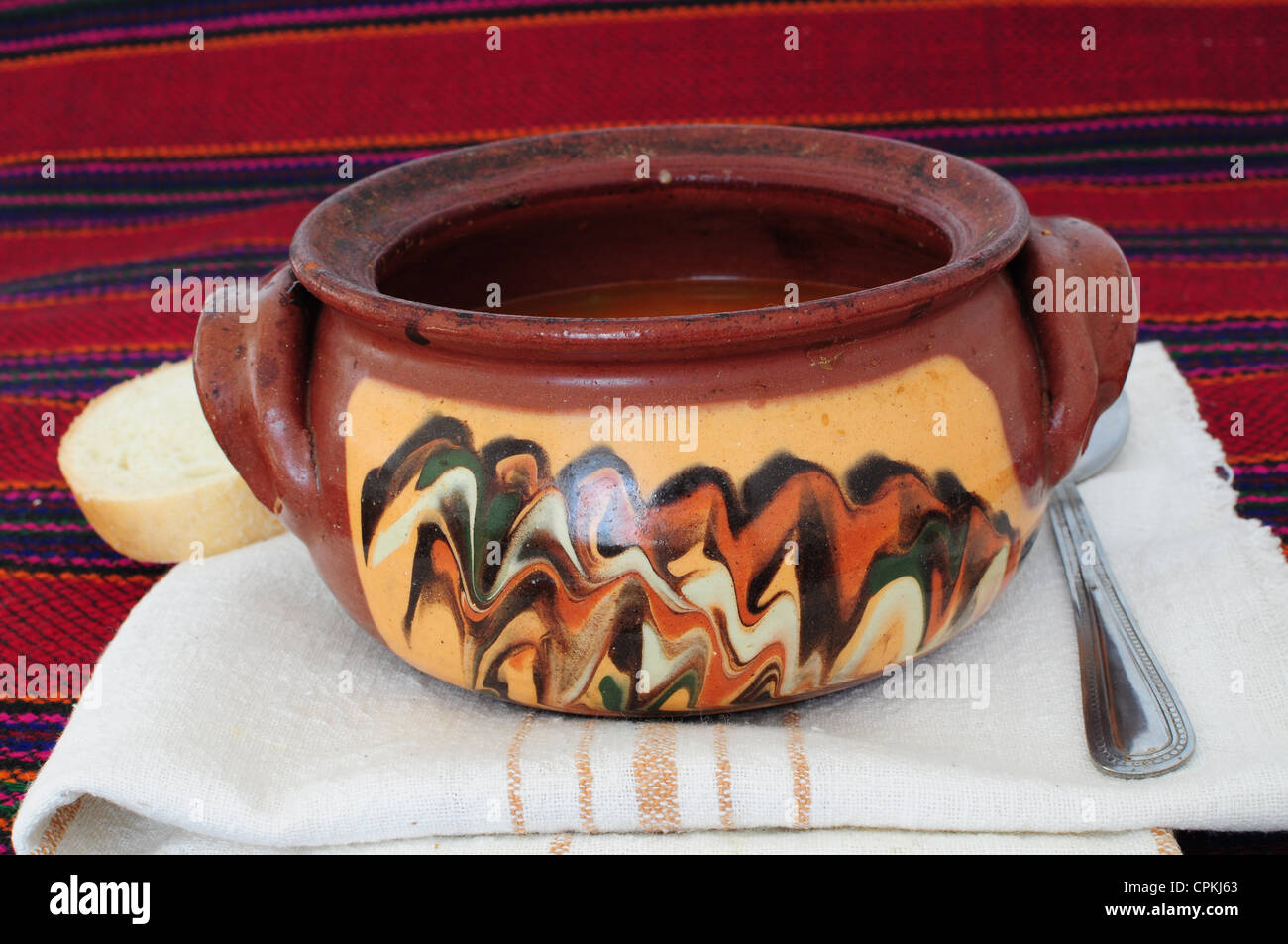 Traditional dish served in decorated clay pot for cooking Stock Photo