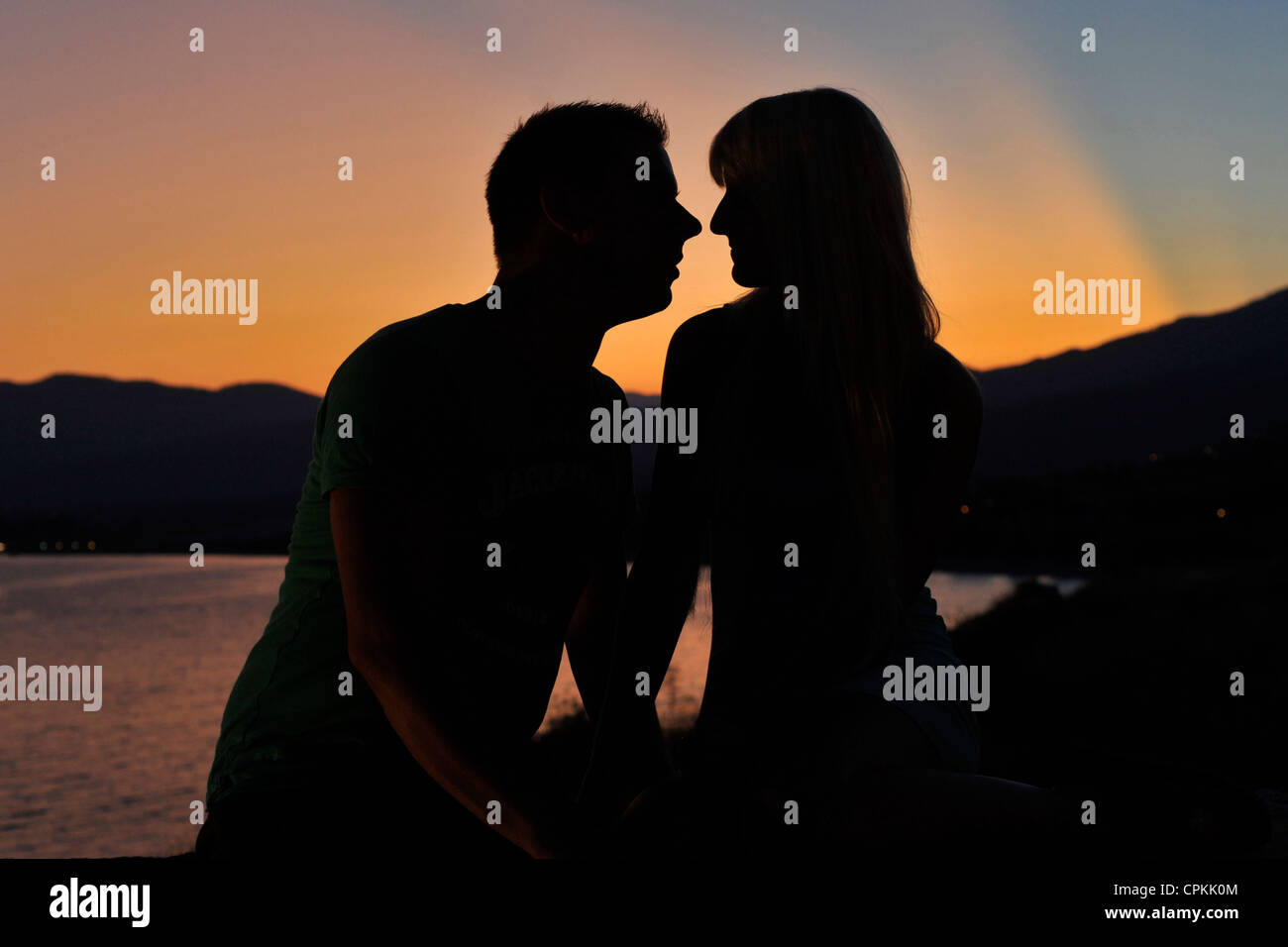 Young couple at sunset on sea side. Stock Photo