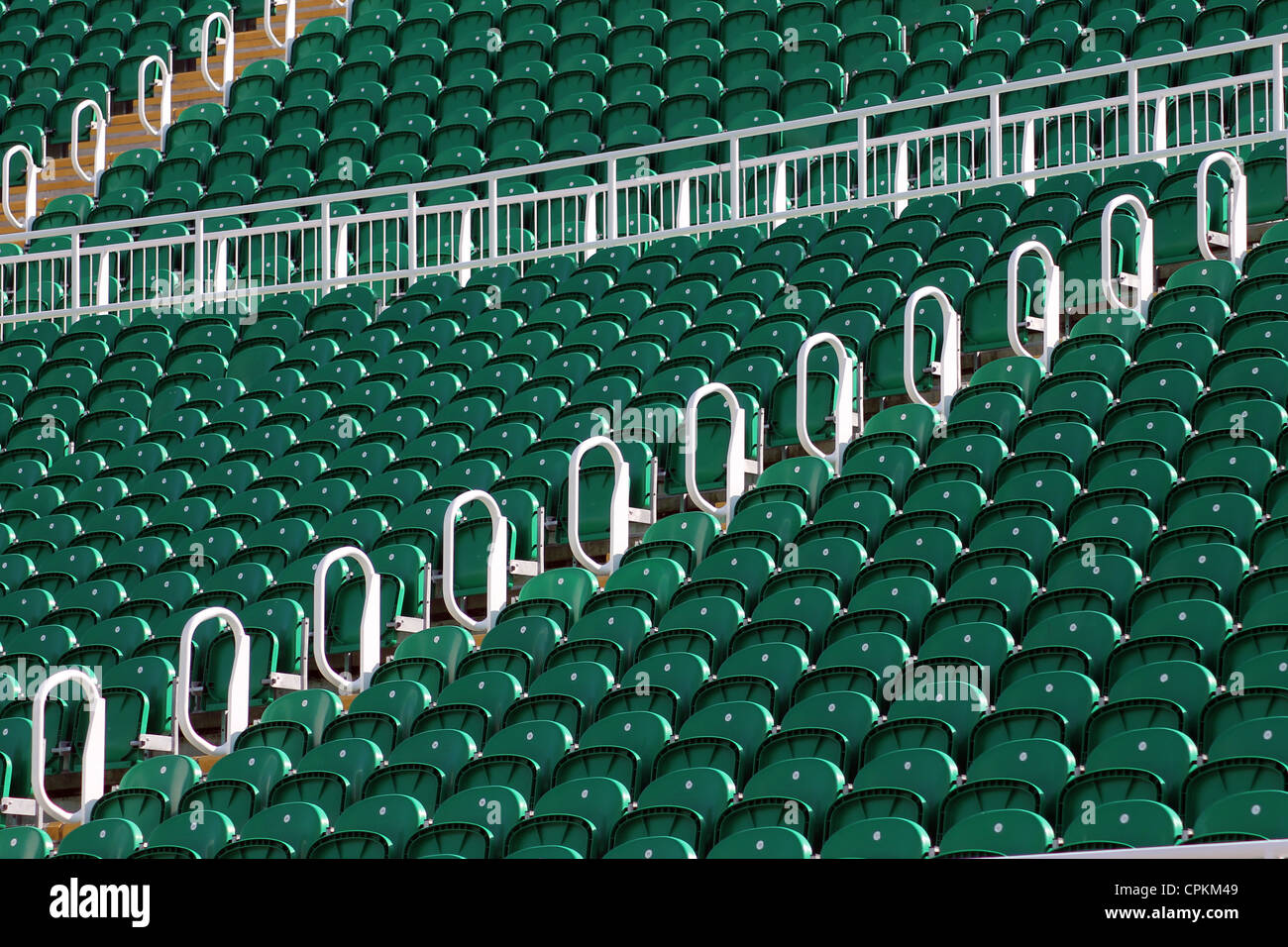 Rows of green seating in stadium outdoors, low angle Stock Photo