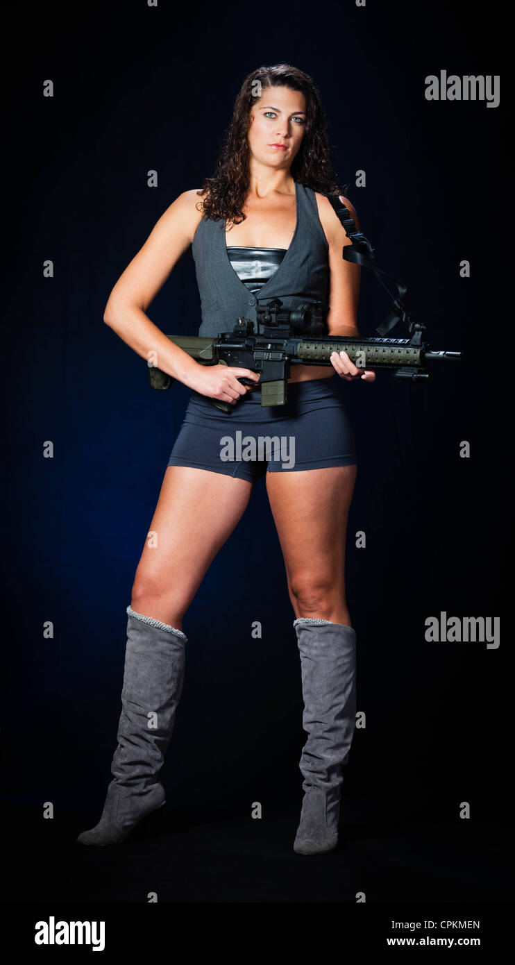 Beautiful tall assassin with AR-15 assault rifle Stock Photo