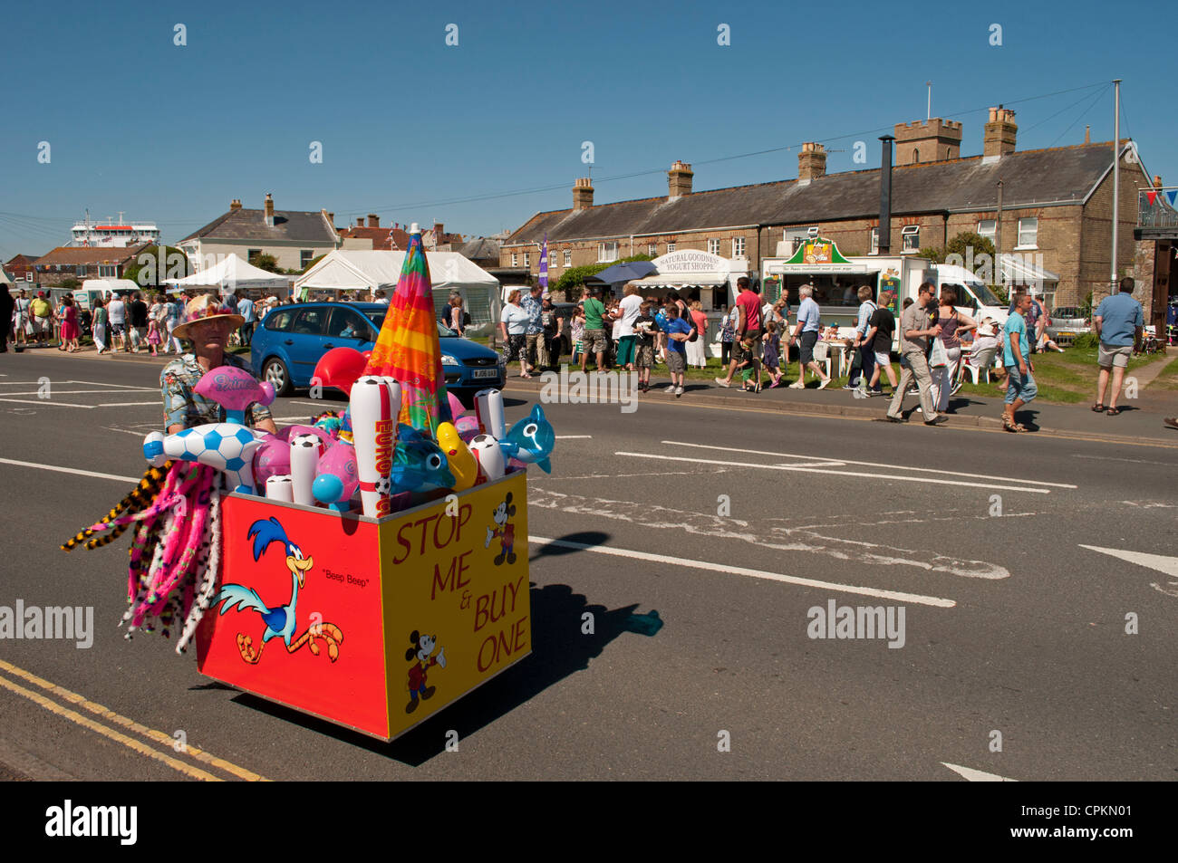 Stop Me And Buy One cart being pushed along by female street vendor during Yarmouth Old Gaffer's Festival 2012,  Isle of Wight. Stock Photo