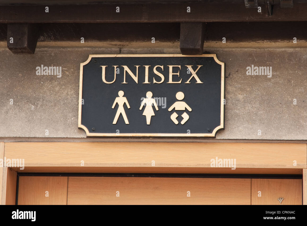 Unisex sign over Public Toilet, Moreton-in-Marsh Stock Photo