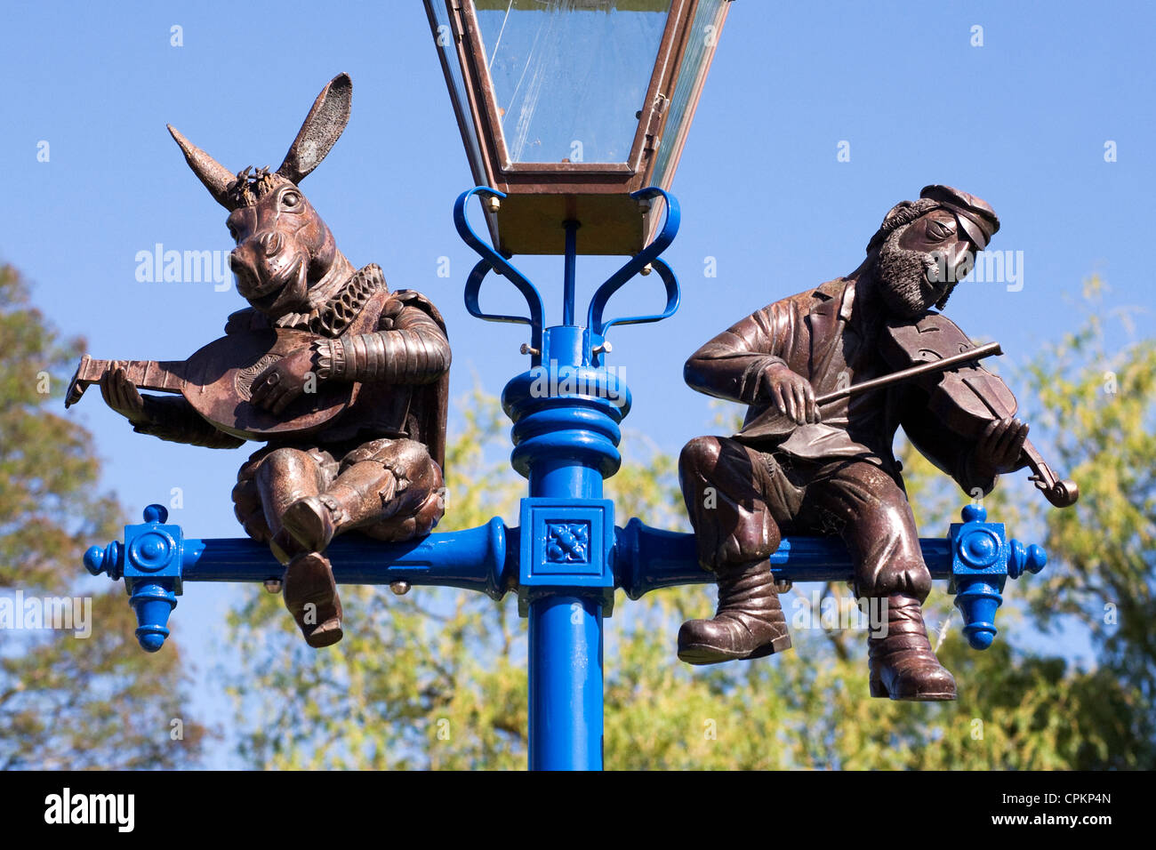 Lamp-post in Stratford upon Avon depicting Bottom and a traditional Jewish fiddler. Stock Photo