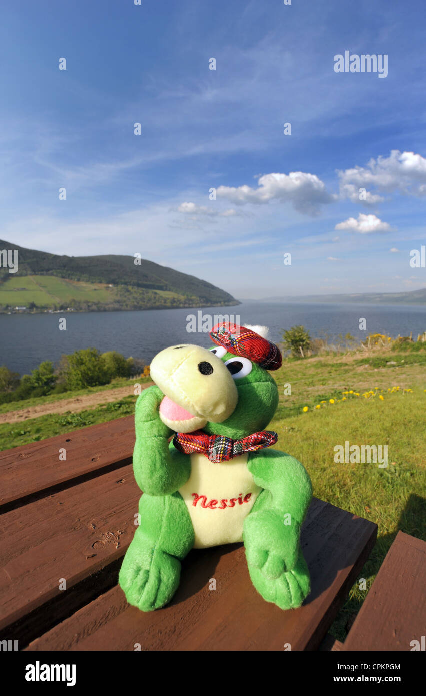 TOY LOCH NESS MONSTER WITH LOCH NESS SCOTLAND IN BACKGROUND RE MONSTER HUNTING NESSIE SPOTTING LEGENDS SOUVENIR STORY  UK Stock Photo