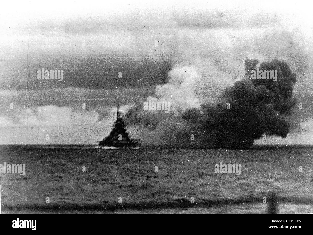 View of the German battleship 'Bismarck' firing on British naval forces, as seen from the German heavy cruiser 'Prinz Eugen' Stock Photo