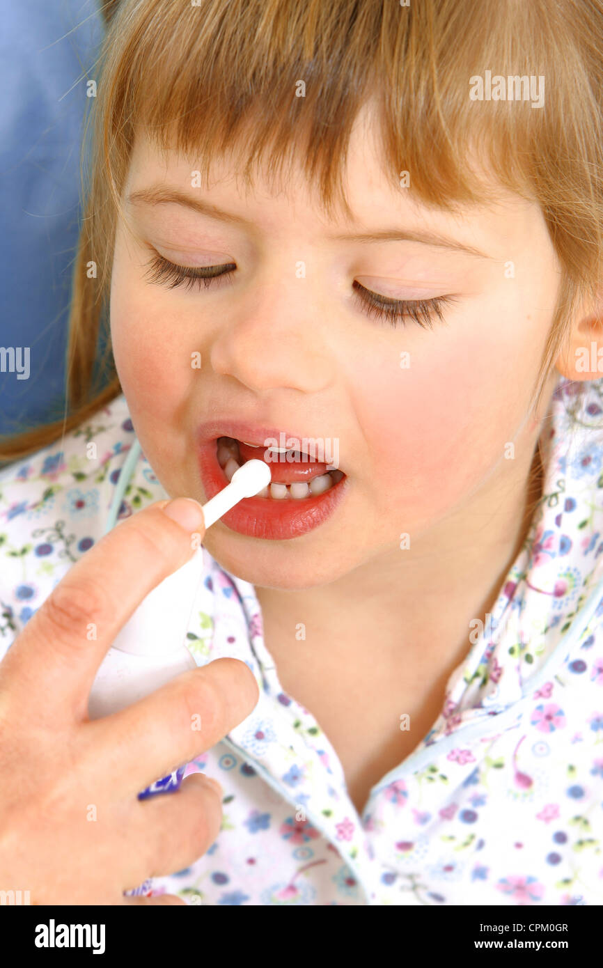 CHILD USING SPRAY IN MOUTH Stock Photo Alamy