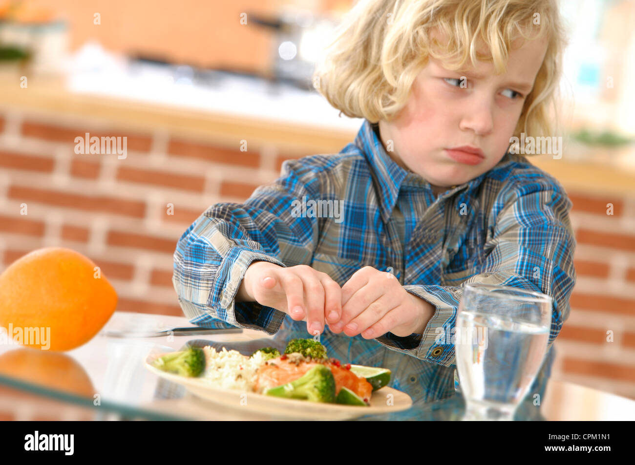 CHILD EATING FISH Stock Photo