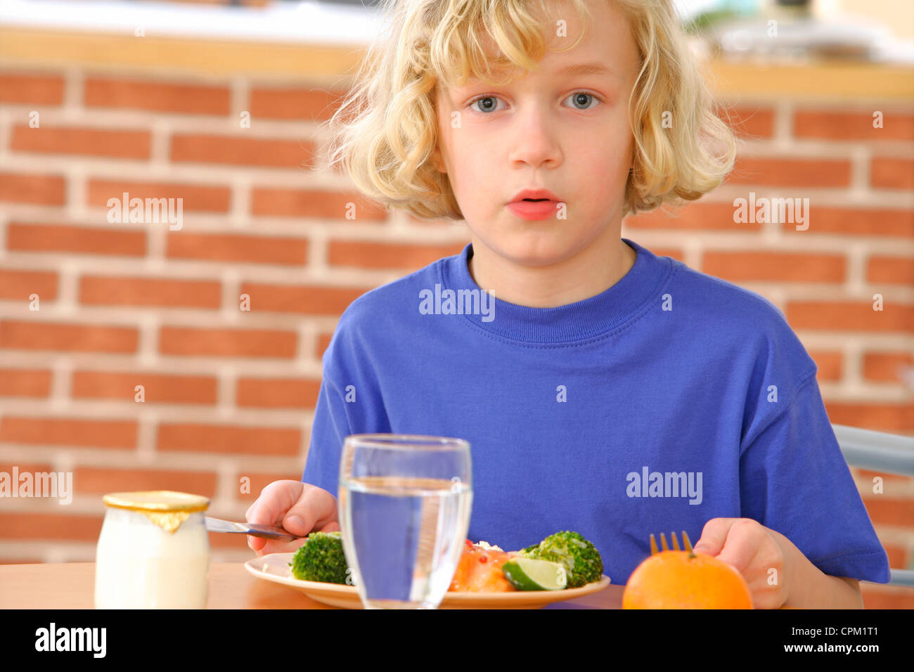 CHILD EATING FISH Stock Photo