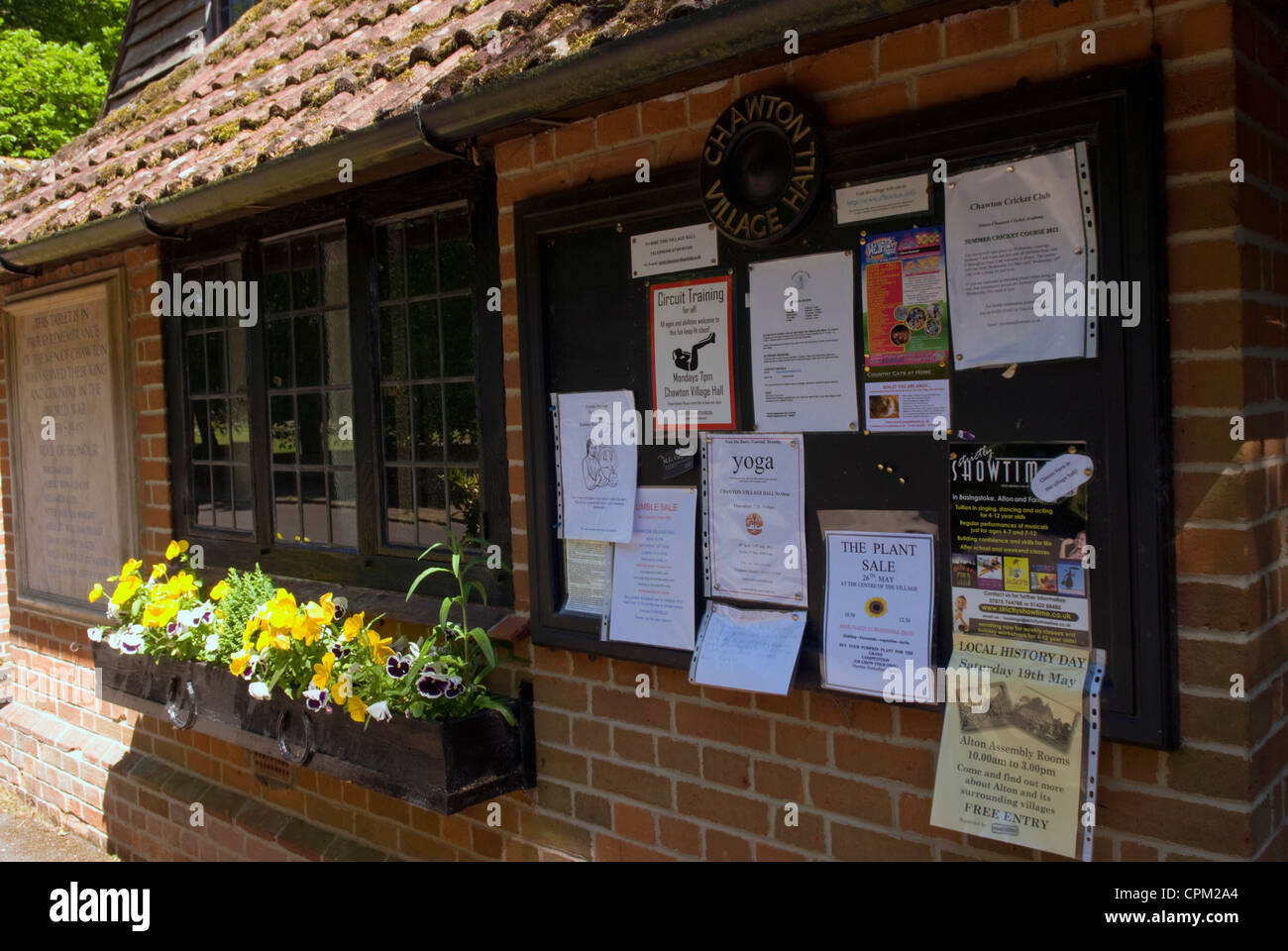 Noticeboard on outside Village Hall in the rural village of Chawton, Hampshire, UK. Stock Photo
