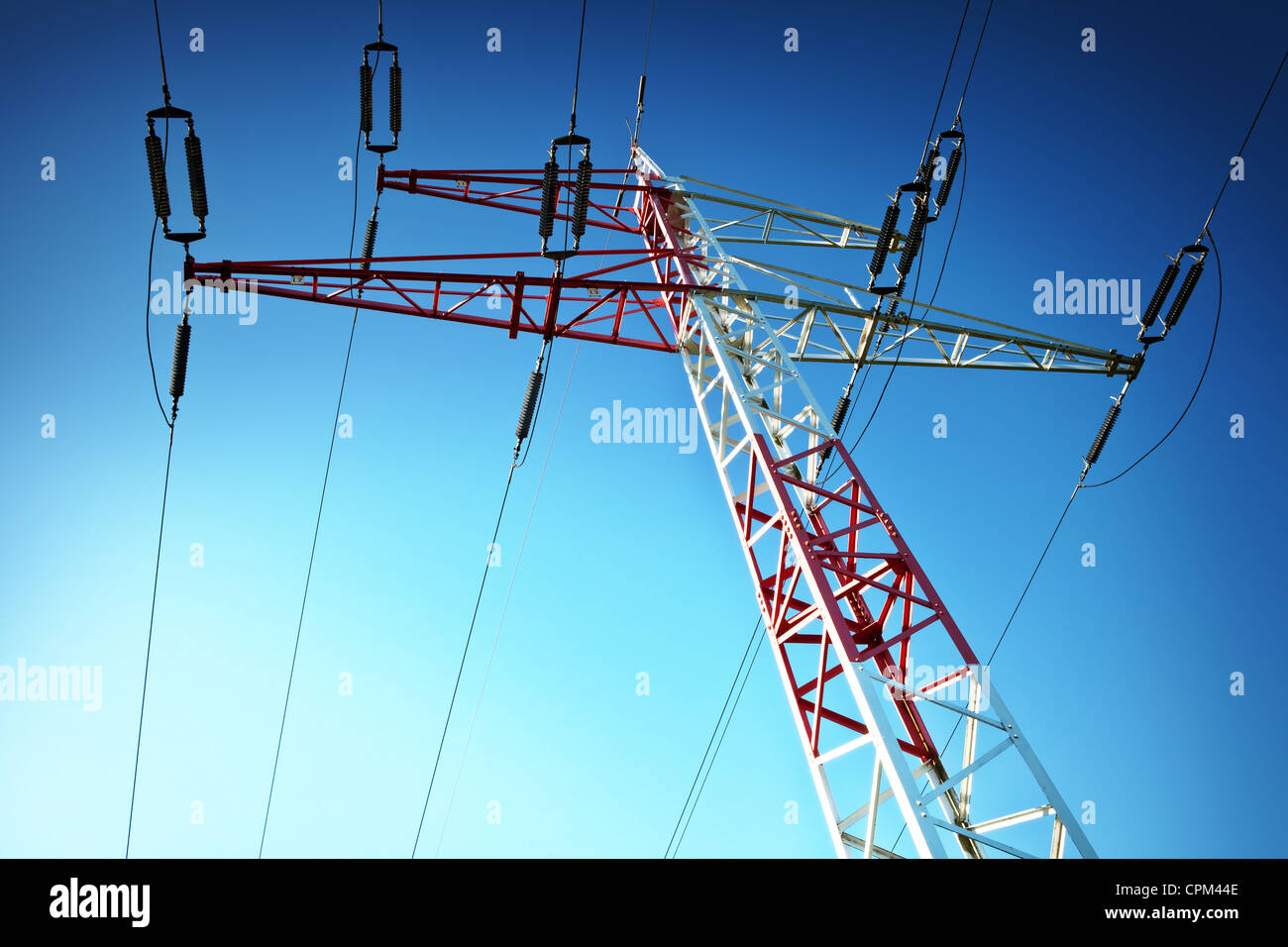 Electric high voltage pylon against blue sky Stock Photo - Alamy