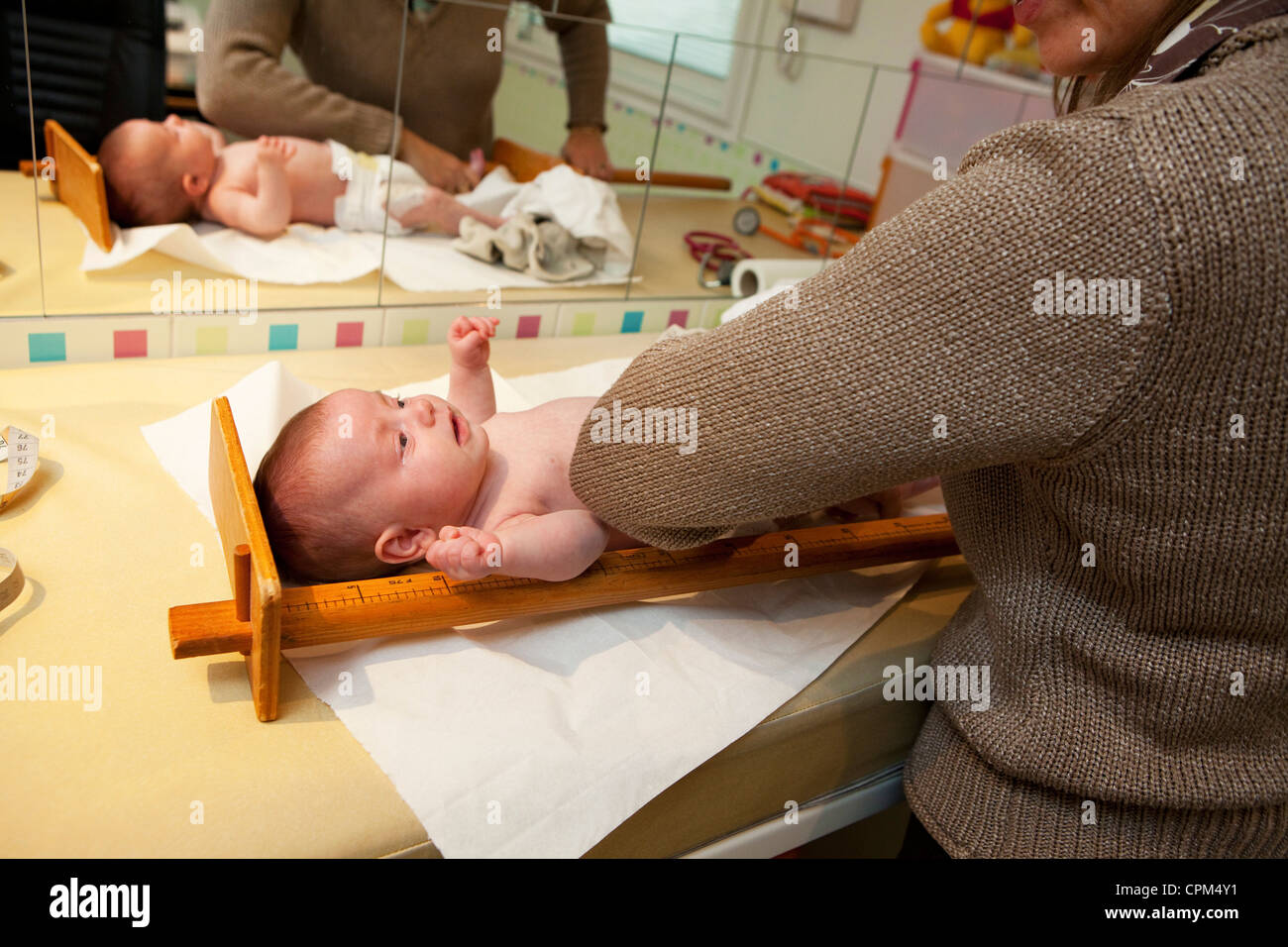 MEASURING HEIGHT, NEWBORN BABY Stock Photo