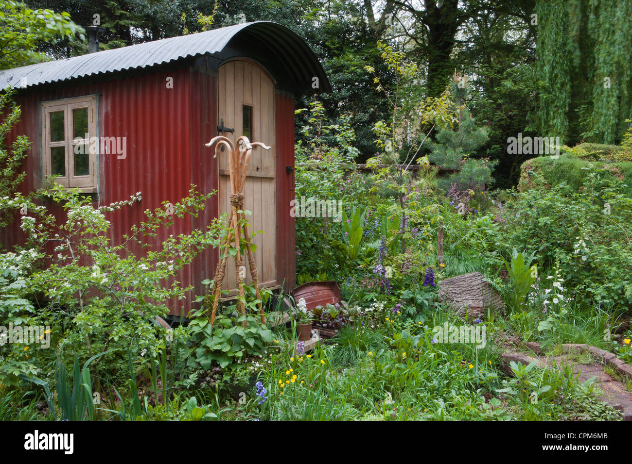 Shepherds hut in a wildflower garden for staycation glamping in the UK Stock Photo