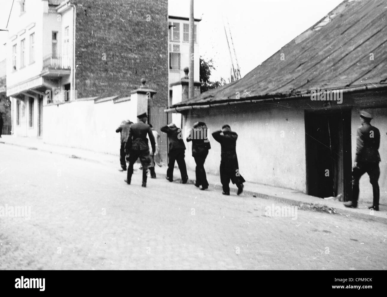 A group of Jews arrested by two German officers, Myslenice, Poland, 1939 (b/w photo) Stock Photo