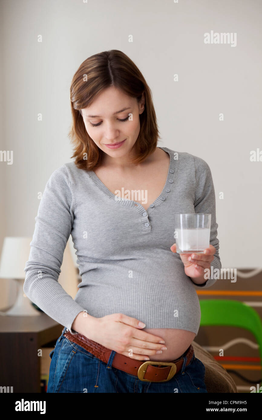 PREGNANT WOMAN TAKING MEDICATION Stock Photo