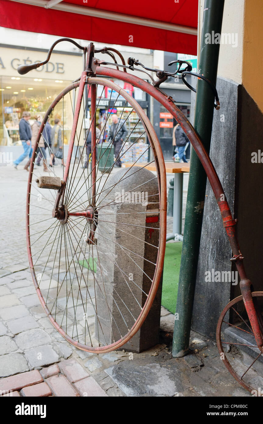 Old Penny Farthing bicycle parked on street Stock Photo