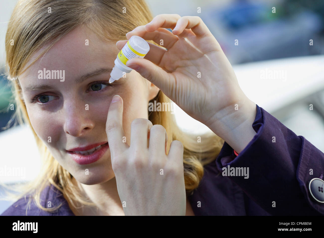 WOMAN USING EYE LOTION Stock Photo Alamy