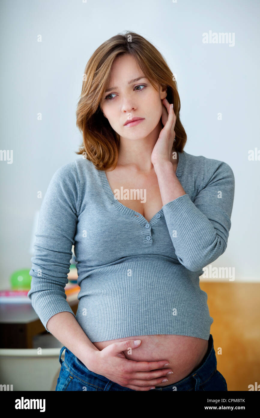 EAR PAIN IN A PREGNANT WOMAN Stock Photo