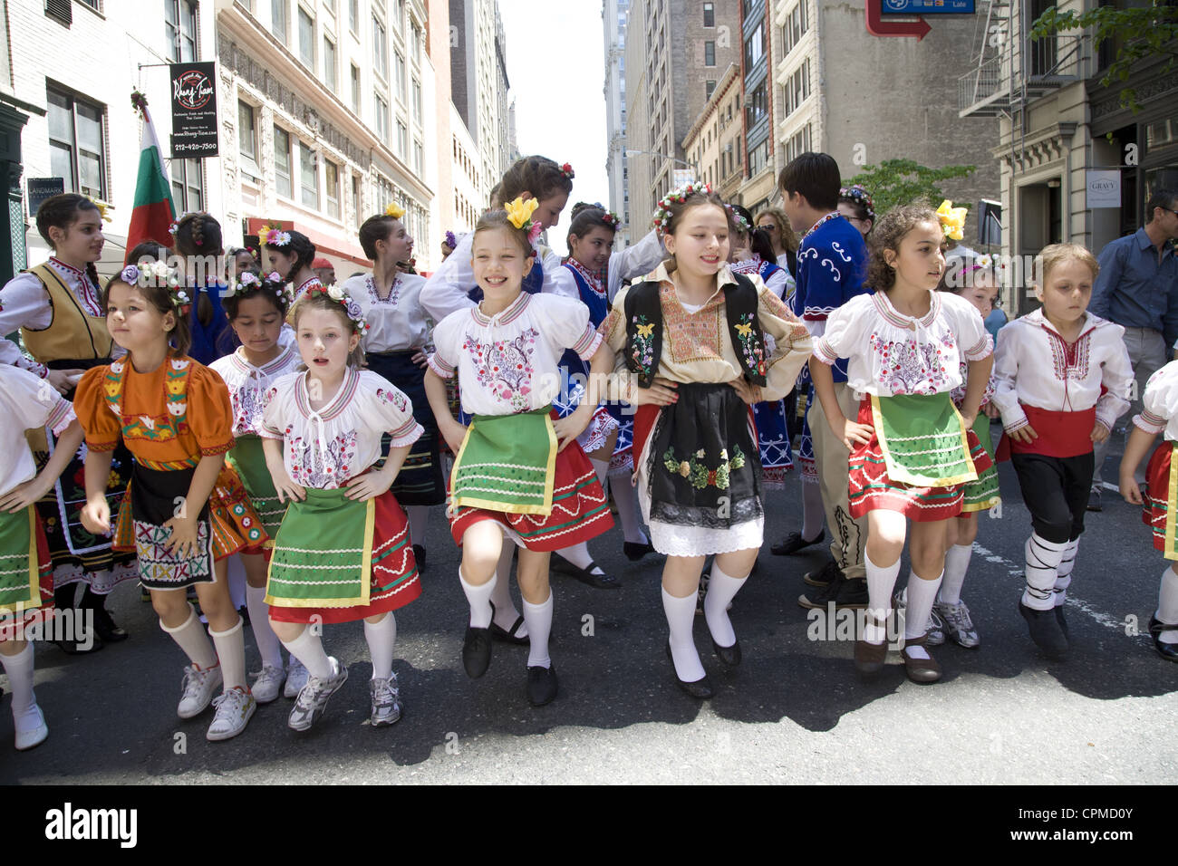 Annual Dance Parade in NYC along Broadway. Child Bulgarian Dance group. Stock Photo